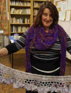 Dawn with a hand knit scarf with a crochet's edge.