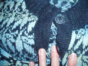 A contrasting button band on a fairisle cardigan