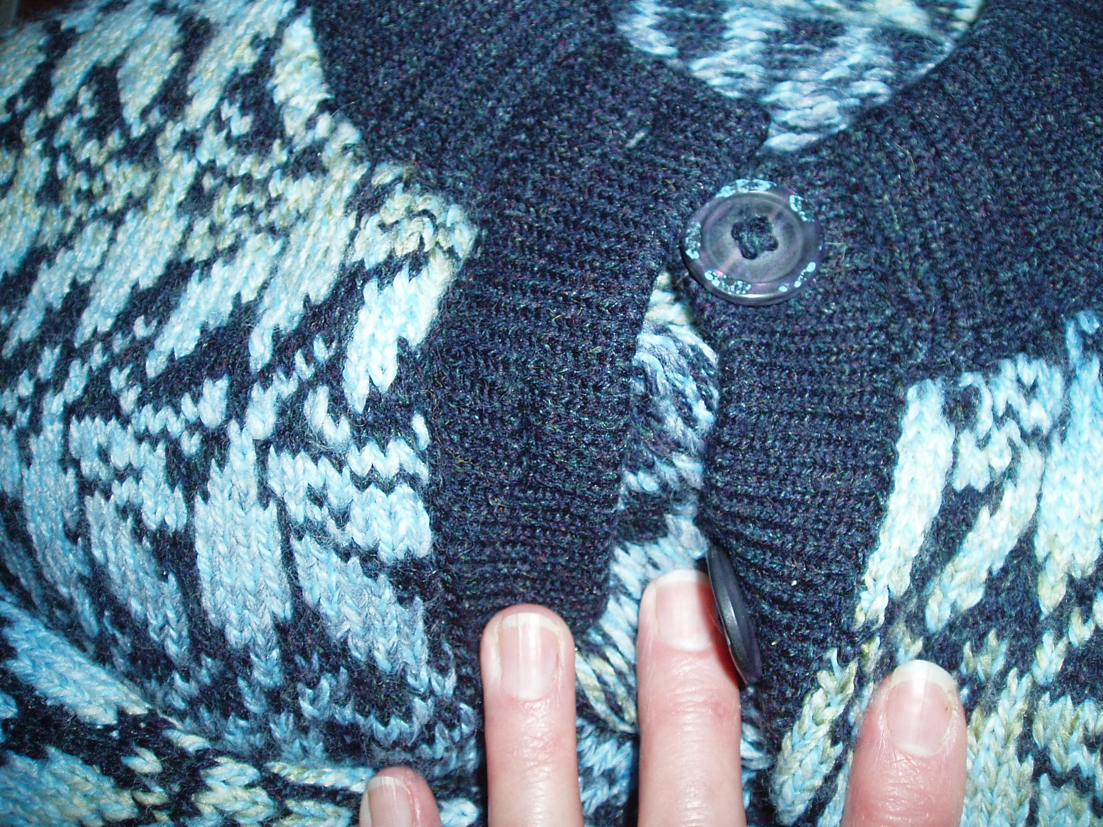 A contrasting button band on a fairisle cardigan