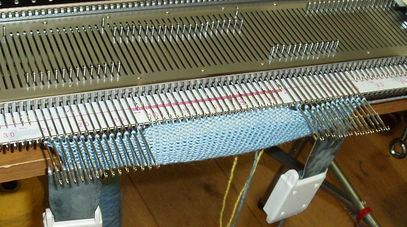 Holding stitiches each side of pocket with I needle out of work